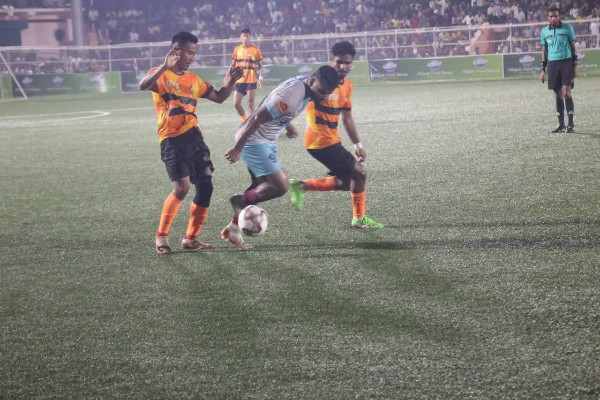 Intense battle for ball possession between Forward & Blood Mouth (Orange-Black jersey) in Rakhal Shield knockout Final