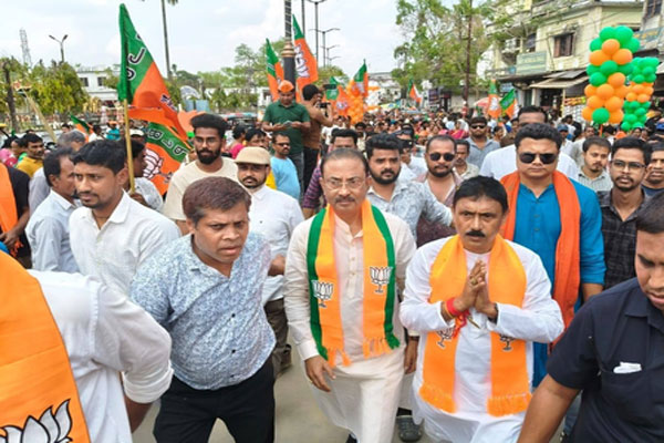 BJP candidate Jahar Chakraborti and supporters during a nomination rally in the streets of Dharmanagar, where women voters hold a majority for the 2026 by-poll.