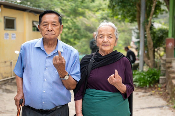 Senior citizens in Aizawl showing their inked fingers after voting in the 2026 Mizoram civic polls.