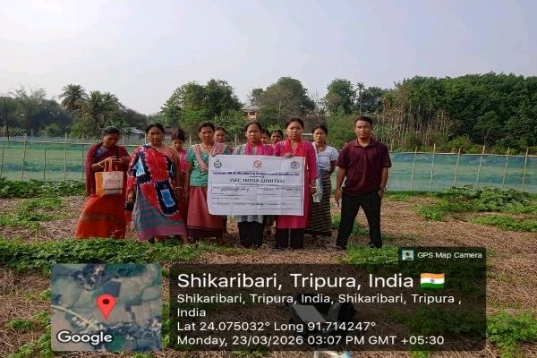 A group of women farmers and an official in Shikaribari, Tripura, holding a TRESP banner during a Farmer Field School session on modern agricultural technologies.