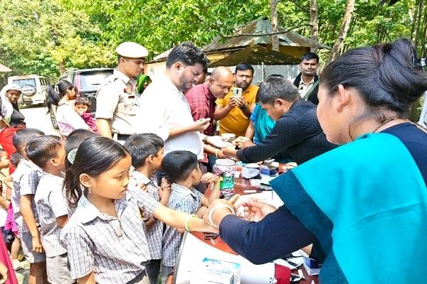 Health workers and officials conducting a medical screening and distribution camp in a rural area of South Tripura under the IMEC 2026 campaign.