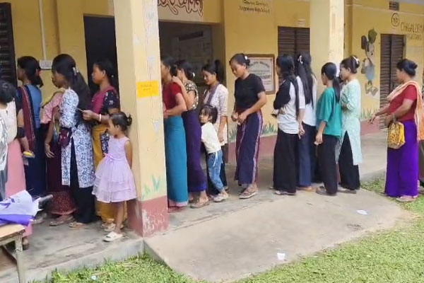 Janajati people stand in queue at a polling station to cast their votes for the TTAADC 2026 polls 