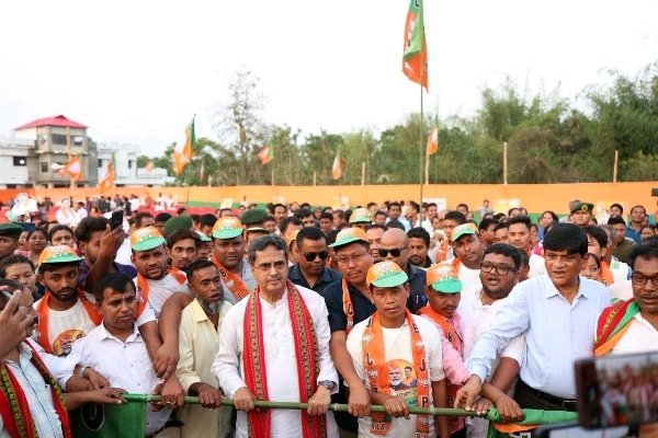 Tripura Chief Minister Dr. Manik Saha standing with BJP supporters at a political rally in Paharpur.