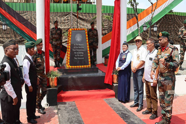 Senior military officers and Mizo leaders stand before the newly renovated black stone War Memorial in Lunglei, decorated with marigold garlands.