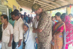 Security forces assisting elderly woman at a polling booth during West Bengal Assembly Election 2026 phase 2