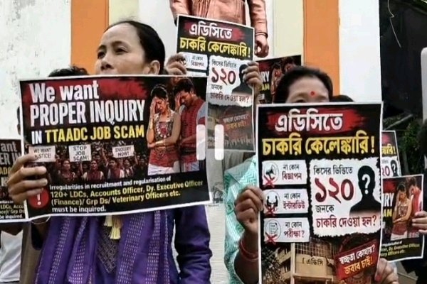 Unemployed tribal youth in Tripura holding protest placards against the TTAADC job scam in Agartala.
