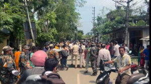 Protesters and security forces at a road blockade in Dharmanagar, North Tripura, following the death of BJP leader Rahul Kishore Roy.
