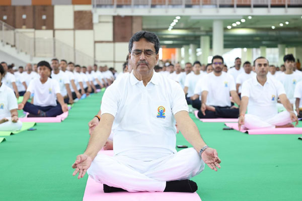 Tripura Chief Minister Dr. Manik Saha performing pranayama along with others at Hapania International Exhibition Hall in Agartala.
