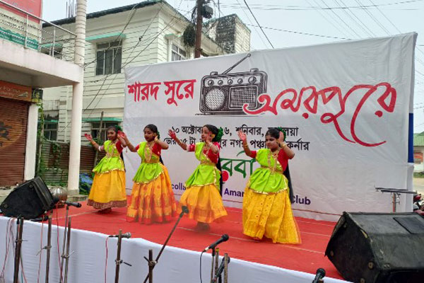 Young girls performing traditional Bengali dance on stage during Mahalaya cultural events at Amarpur in Tripura