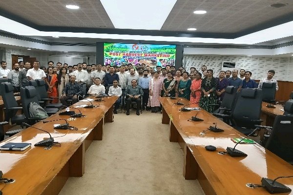 Participants pose for a group photo in a conference hall during a TRESP post-harvest marketing training workshop.